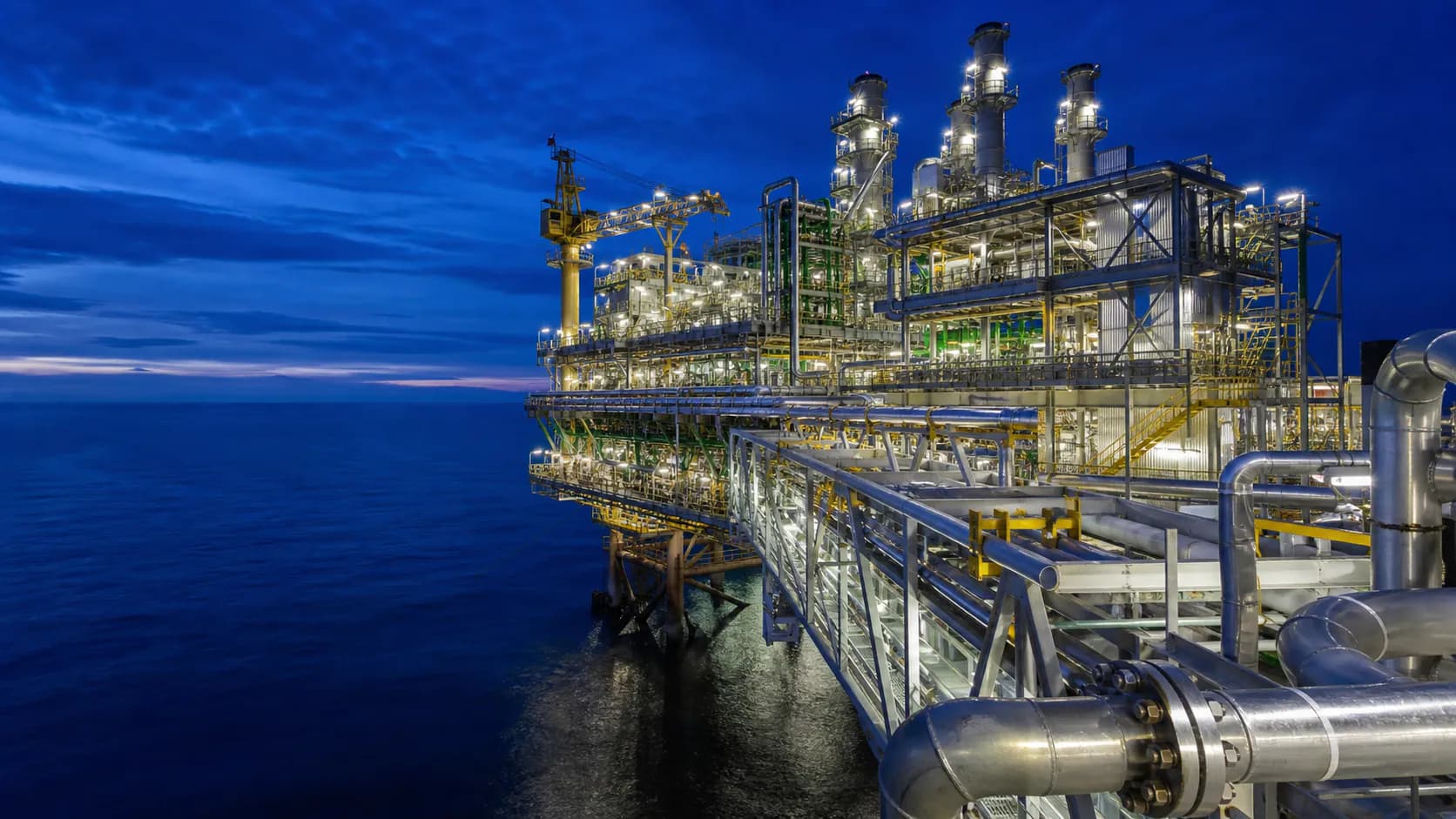 Illustrative modern offshore production platform with process modules and installed piping