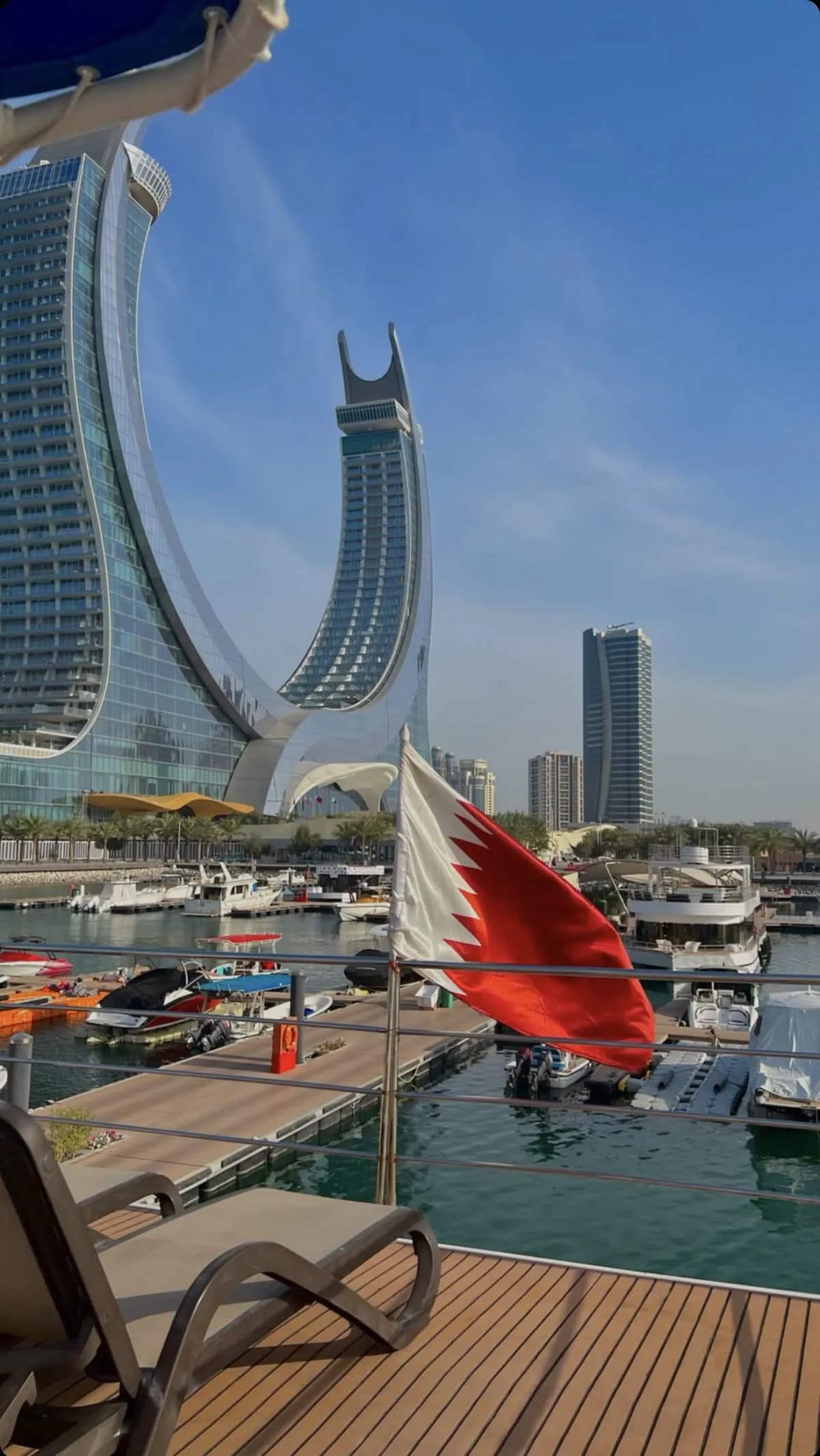 Doha waterfront business district and Qatar national flag