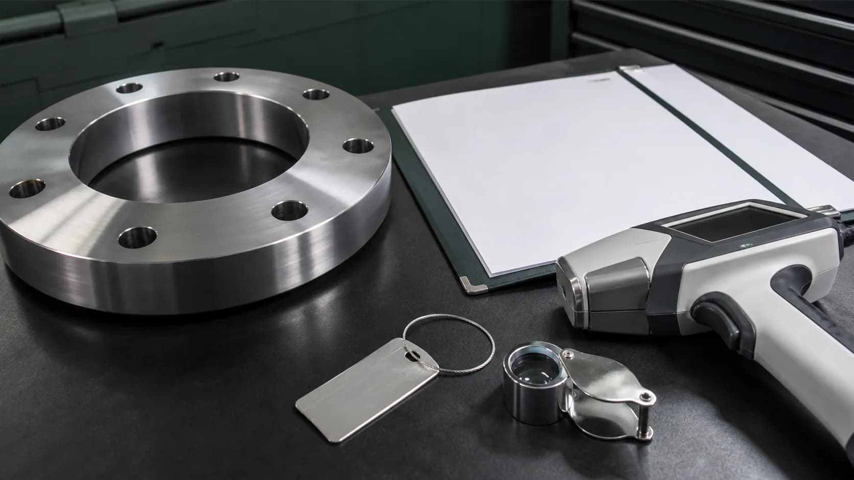 Illustrative alloy flange quality evidence workspace with a PMI analyser and blank document folder